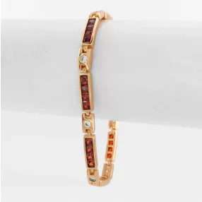 Aranyszínű antiallergén karkötő bordó kristályokkal