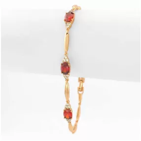 Aranyszínű antiallergén karkötő bordó kristályokkal