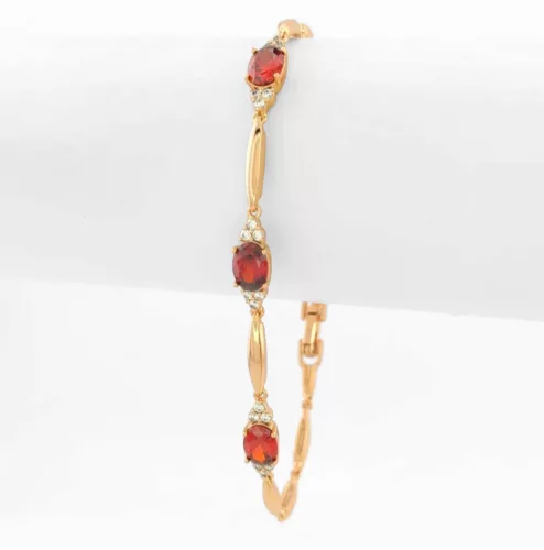 Aranyszínű antiallergén karkötő bordó kristályokkal